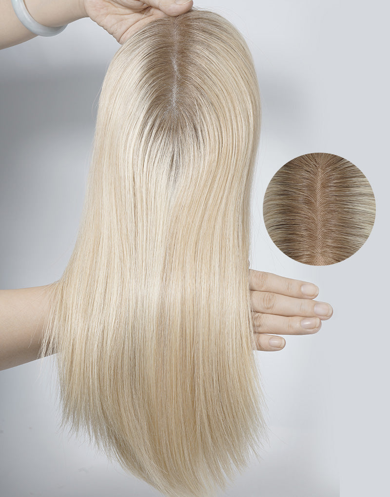 Close-up of a blonde 5.5x6 fine mono human hair topper showing a realistic hand-tied scalp parting and natural dark roots for seamless blending.
