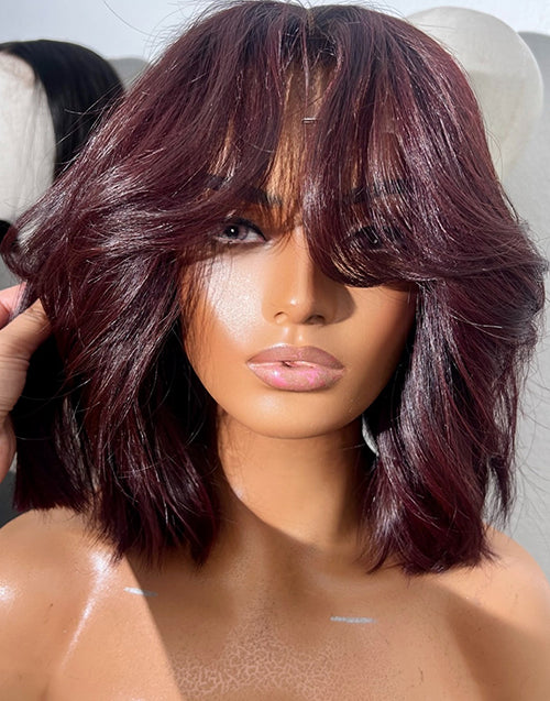 Front view of 99J burgundy red wavy short blunt cut bob glueless wig with face-framing curtain bangs for women.
