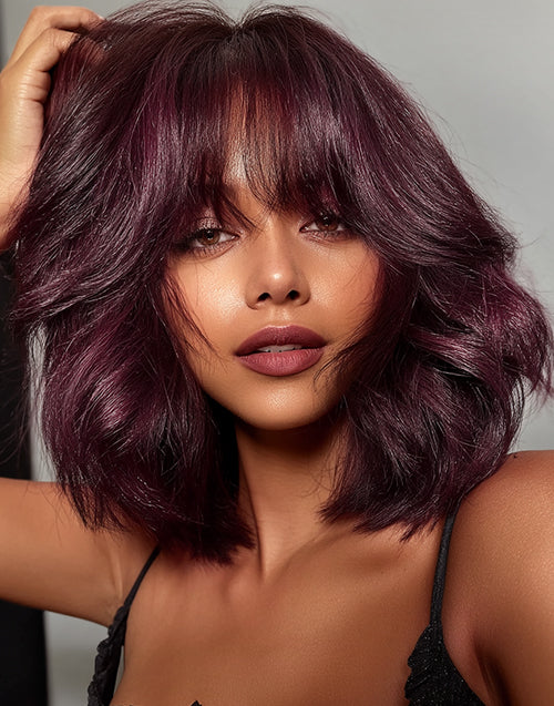 Model close-up wearing 99J burgundy red wavy short blunt cut bob glueless wig with face-framing curtain bangs. Natural everyday look.