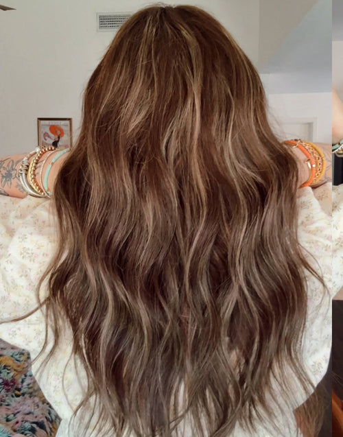 Long, wavy brown hair with subtle blonde highlights, shown from behind on a person wearing a white floral top and colorful bracelets.