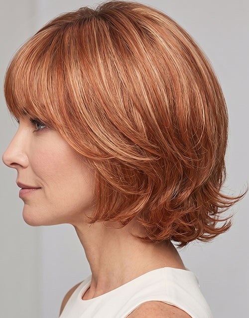 Left side profile shot of the Alma strawberry blonde highlighted short wavy bob wig.