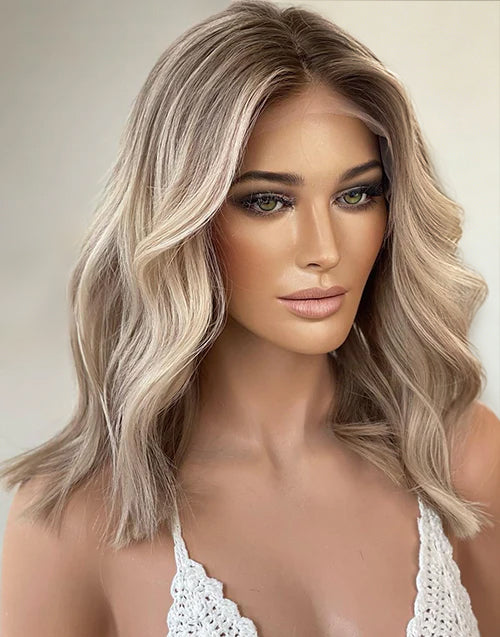 Woman wearing a cool-toned ash blonde highlight wavy short bob human hair wig.