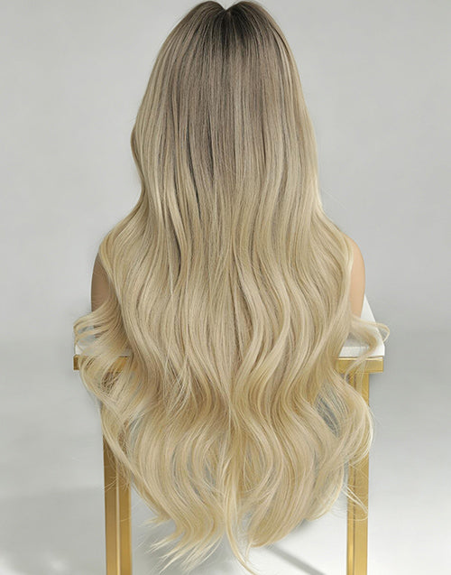 Long wavy ombre wig shown from the back, featuring dark brown roots that fade into light blonde lengths.