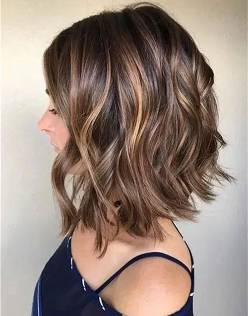 Left side profile view of a short wavy bob human hair wig featuring soft caramel and honey balayage highlights