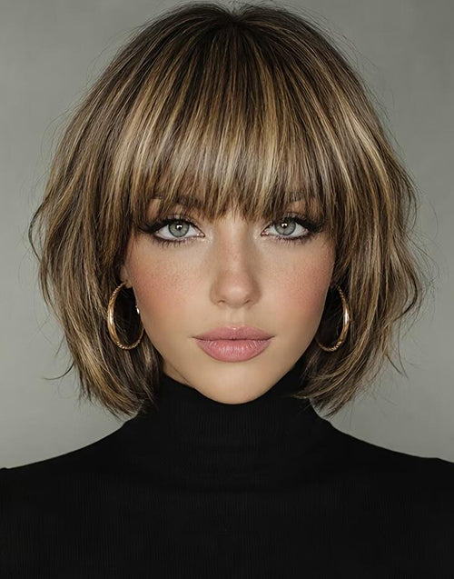 Front portrait view of a model wearing the Berry balayage golden blonde short bob wig with full bangs