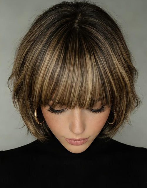 Top-down view of a model wearing the Berry balayage golden blonde bob wig with bangs