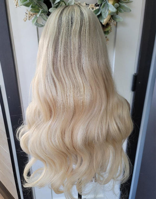 Back view of Betti natural wave lace frontal wig with blonde highlights.