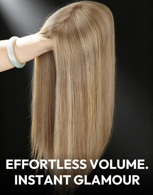 Blonde human hair topper held by hand showing silky texture and realistic scalp