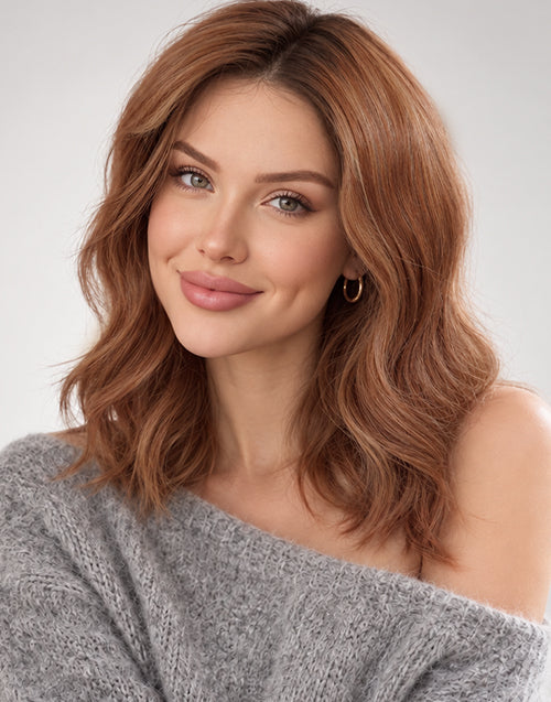 A woman with a shoulder-length copper brown with highlight wavy bob wig.