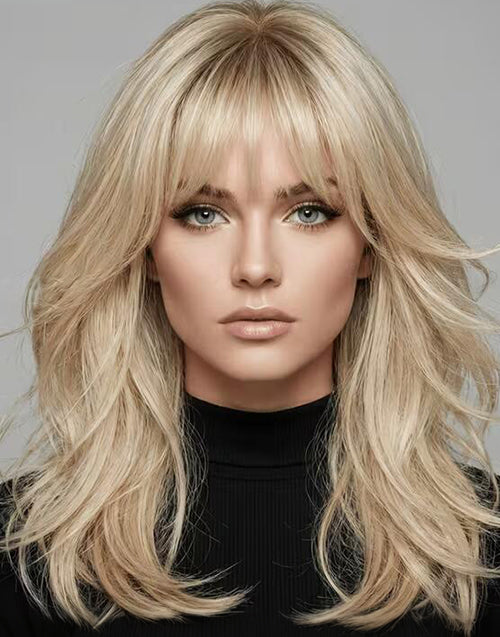 Woman with long blonde hair and bangs against a gray background