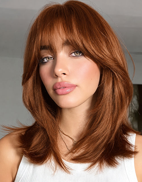 Front view model wearing Beth burnt orange straight layered bob wig with face-framing curtain bangs.