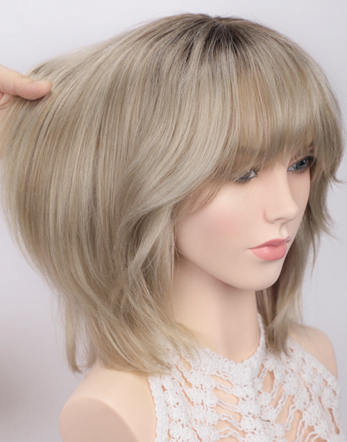 Side profile of Joy Minimalist Lace Wig: Hand holding 100% human hair in Ombre Ash Blonde, showing soft layered bob volume and natural dark root blending on a mannequin.