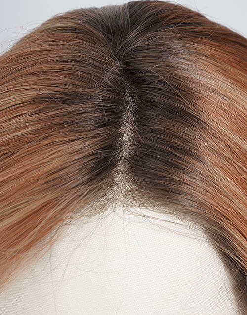 Detailed close-up of a realistic lace front wig parting space with natural dark roots transitioning into warm copper brown highlight hair.