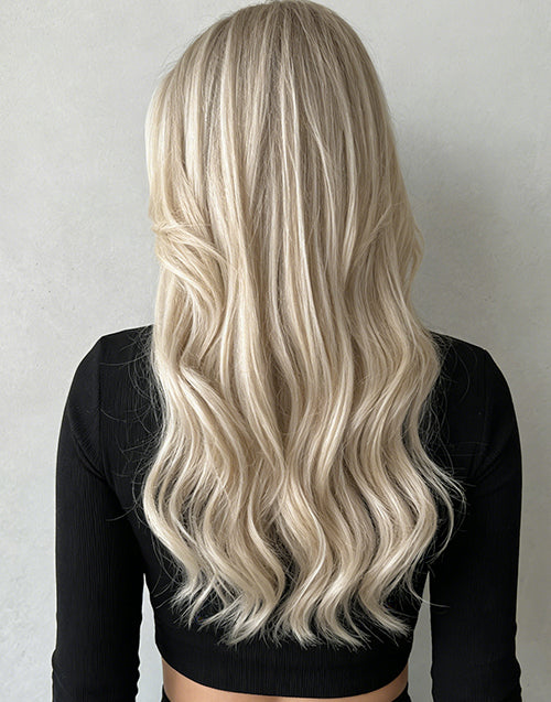Back view of light blonde balayage wavy wig with flowing waves.
