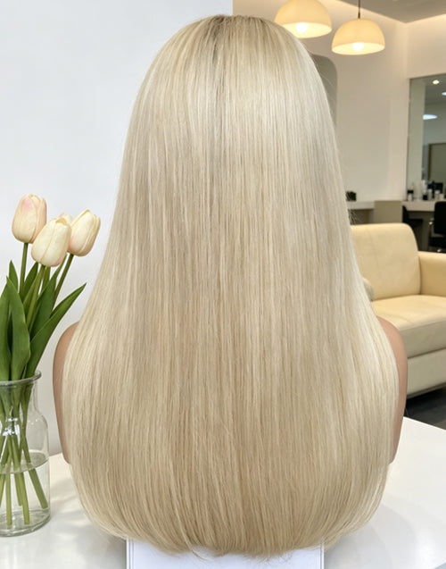 Rear view of a premium long straight platinum blonde wig, showcasing its silky texture and natural hair density, styled professionally at our luxury salon.