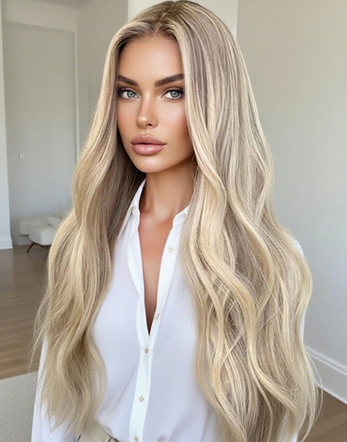 Close-up view of a long wavy human hair wig in warm ash blonde balayage