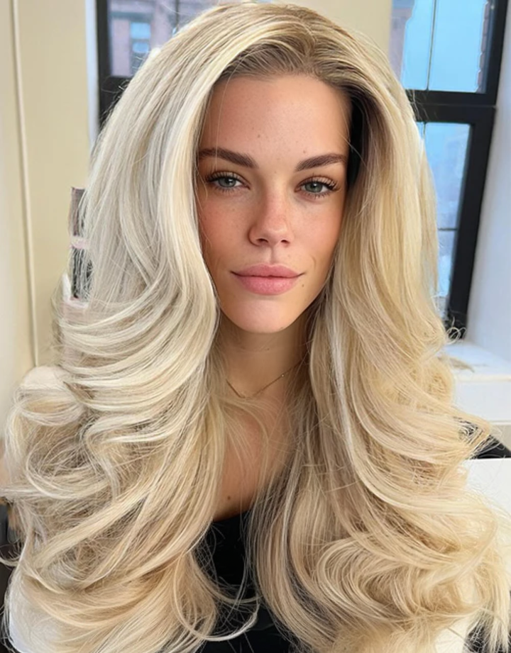 Ombre highlight blonde 13x6 lace front glueless human hair wig worn by a model, featuring a natural pre-plucked hairline and voluminous body waves.