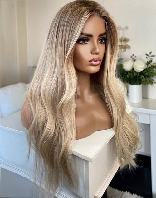 Mannequin display of the Ophelia ash blonde balayage human hair wig, showcasing the long wavy texture.