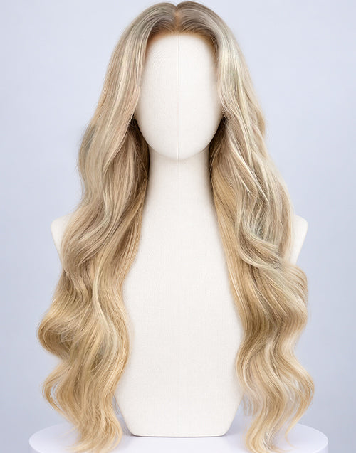 Front view of a long wavy platinum blonde balayage lace front wig with dark shadow roots