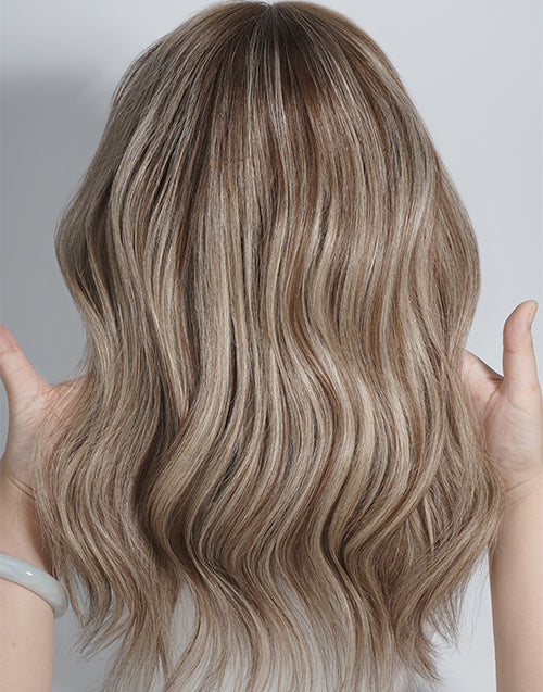 Long wavy wig with a highlighted blonde color, shown from the back with hands holding the hair out to the sides against a light gray background.