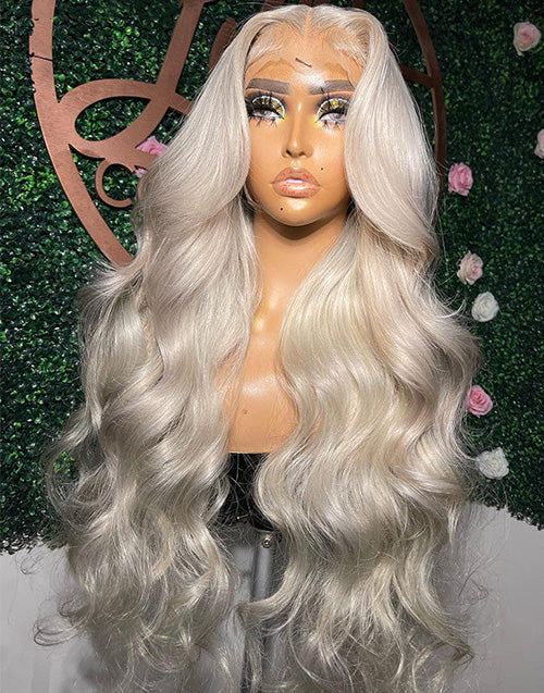 Front view of a platinum blonde body wave wig with soft waves and a natural lace front.